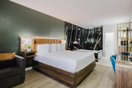 a hotel room with a bed and a chair at SureStay by Best Western Morgan Hill in Morgan Hill
