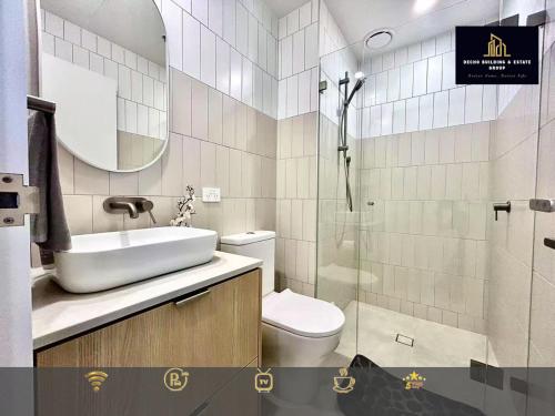 a bathroom with a sink and a toilet and a shower at C04-Summerfield Stylish 2BR Apart, Mountain view in Weston Creek