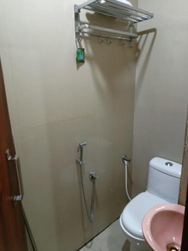 a bathroom with a toilet and a sink at Mark inn hotel in Hanumāngarh