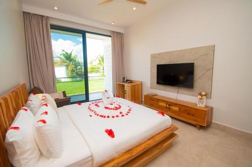 a bedroom with a bed with a cake on it at DT Beachfront Villas Hotel & Spa in Mkunguni