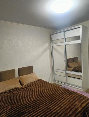 a bedroom with a bed and a large window at 2 кімнатні апартаменти в центрі міста in Pavlohrad