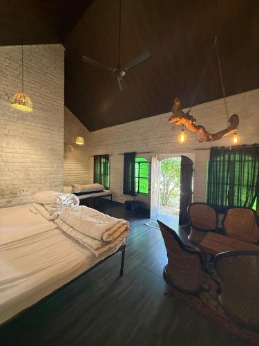 a large bedroom with a large bed and chairs at Shannu's Ranch Inn in Pushkar