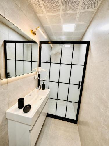 a bathroom with a white sink and a mirror at Kasr-ı Cihan Boutique Hotel in Midyat