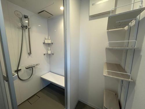 a small bathroom with a shower and a toilet at Villa ORAN in Nakafurano