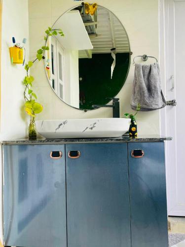 a bathroom with a sink and a mirror at RK Homes in Delhi