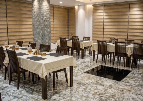 a restaurant with tables and chairs in a room at GaYuel in Thimphu