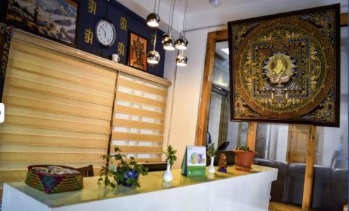 a room with a table with a clock on the wall at GaYuel in Thimphu