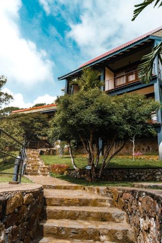 a house with stairs leading up to it at Melheim Resort & Spa Haputale - An Infinite Escape into the Paradise in Haputale