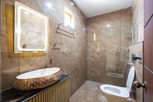 a bathroom with a sink and a toilet and a shower at Krish Inn in Chidambaram