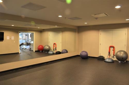 a gym with a bunch of exercise balls on the floor at Monki Di Executive Suites - Alura in Calgary