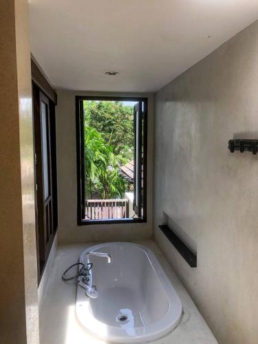 a bathroom with a sink and a window at Sea view apartments in Nathon Bay