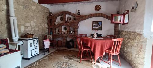a kitchen with a table and chairs in a room at Casa Szatina in Kishajmás