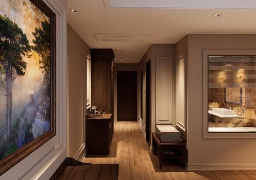 a bathroom with a large painting on the wall at Dalabiang Hotel in Da Lat