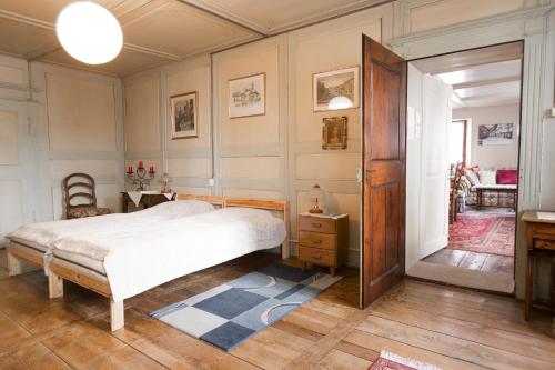 a bedroom with a bed and a wooden door at Appartement ambiance vieux chalet in Sembrancher