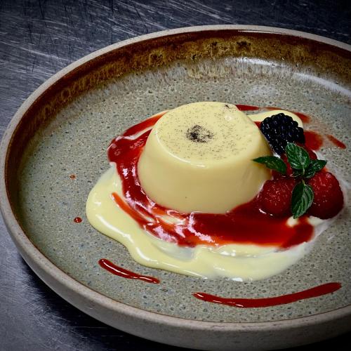 a plate of food with a piece of cheese and berries at Wandering Trout in Mole Creek
