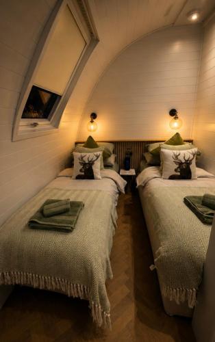 two beds in a room with an attic at Leisure Lodges in Glastonbury