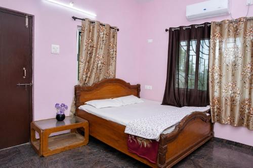 a bedroom with a bed and a window at Samarth Villa in Akalkot