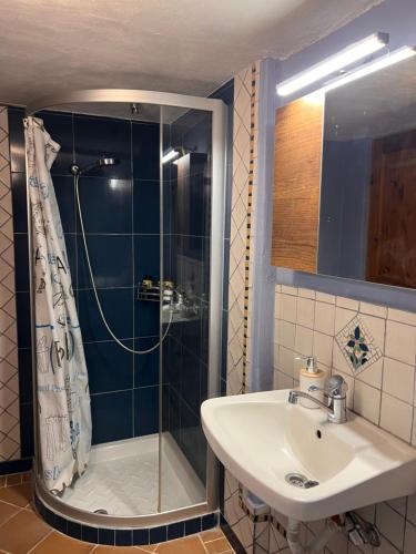 a bathroom with a shower and a sink at Mia's Atelier in Kamária