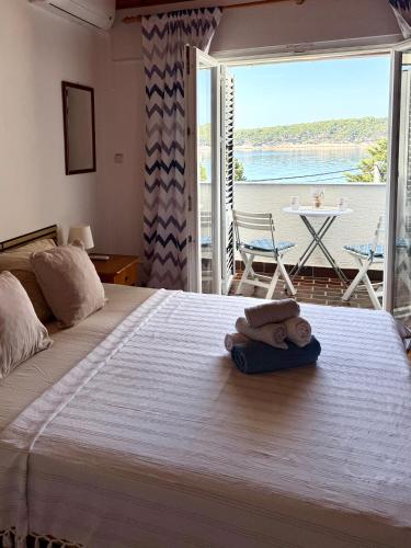 a bedroom with a bed with a view of the ocean at SEA VIEW STUDIO with kitchen, balcony& aircon in Barbat na Rabu