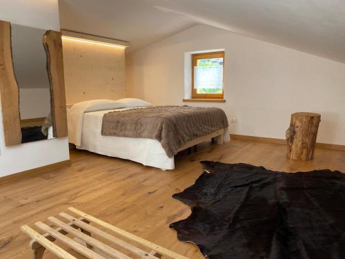 a bedroom with a bed and a wooden floor at Xenìa in Villalago