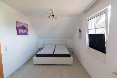 a bedroom with a bed in a room with a window at Ferienhaus Bergblick in Redlham