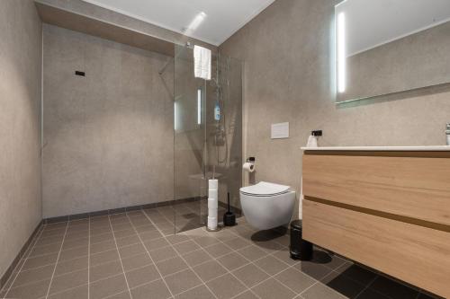 a bathroom with a toilet and a shower and a sink at Olden Fjord View in Olden