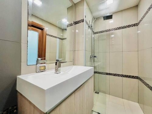 a white bathroom with a sink and a shower at Laguna Beach Resort 2 Pattaya in Jomtien Beach