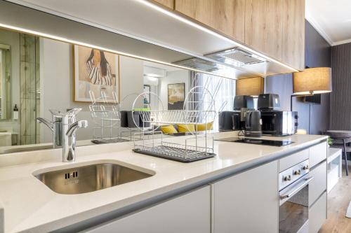 a kitchen with a sink and a microwave at Lux @ Ellipse Galelileo in Midrand