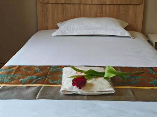 a bed with a towel with a rose on it at Minsu in Mamyr