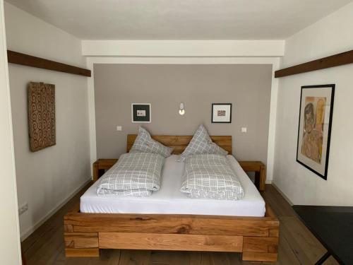 a bedroom with a bed with white sheets and pillows at Chalet im Chiemgau in Siegsdorf