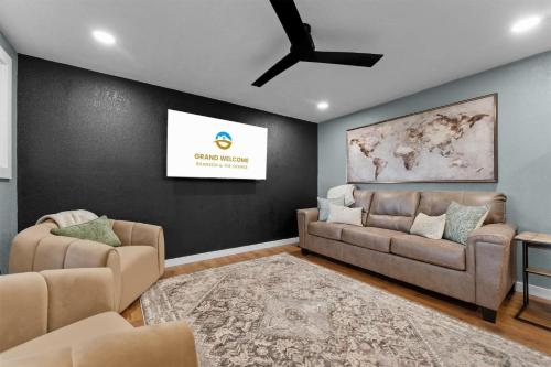 a living room with two couches and a tv at Ozark Skyline Retreat in Branson West