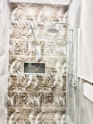 a shower in a bathroom with a shower curtain at Menotti Appartment in Avola