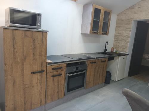 a kitchen with a microwave on top of a counter at Nature et calme d'Angers in Saint-Martin-du-Fouilloux