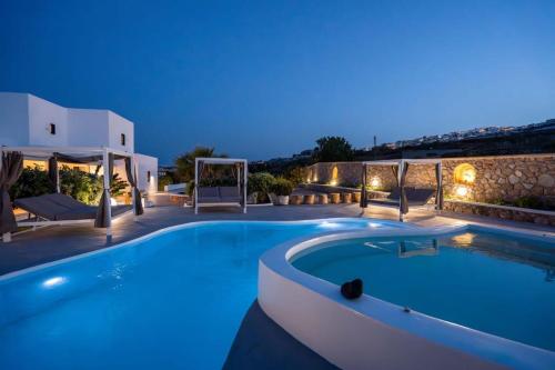 a swimming pool in a villa at night at Maison Palms in Mesaria