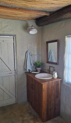 a bathroom with a sink and a mirror at From Valle Hideaway in Tankwa in Sutherland