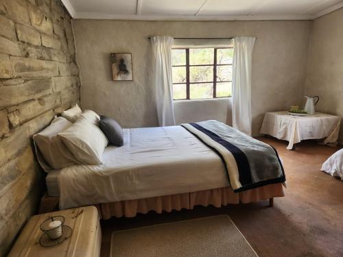 a bedroom with a large bed and a window at From Valle Hideaway in Tankwa in Sutherland
