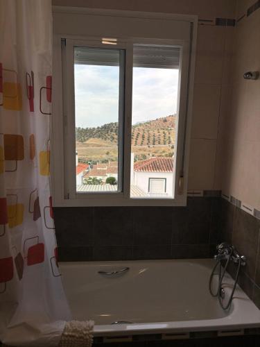 a bath tub in a bathroom with a window at Casa Paula Ardales caminito del Rey in Ardales