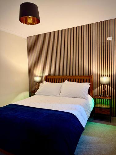 a bedroom with a bed with a wooden headboard at Coorie in Inverness
