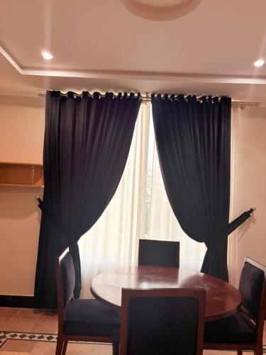 a dining room with a table and a window at Nizalia resorts in Patriata