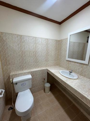 a bathroom with a toilet and a sink at My Dream Wedding in Nathon Bay