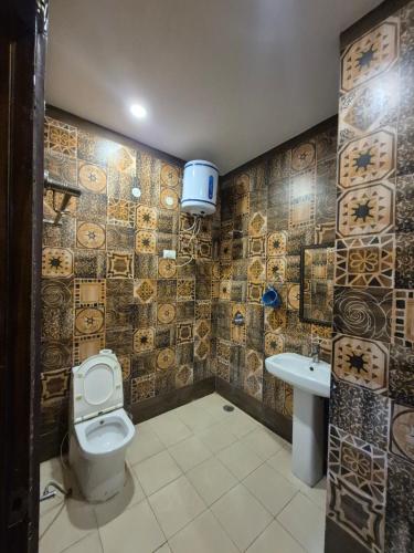a bathroom with a toilet and a sink at Hotel Clover in Zirakpur