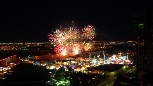 a fireworks display in a city at night at Monki Di Executive Suites - Alura in Calgary