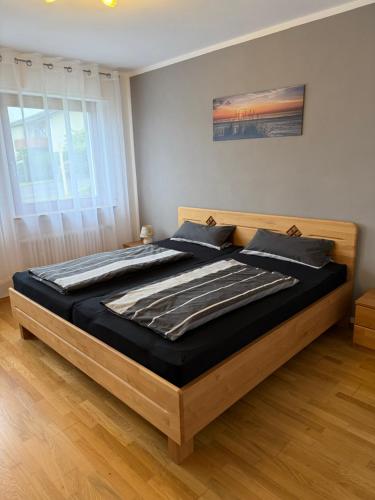a bedroom with a large bed with a wooden frame at FeWo Susanne in Wiehl