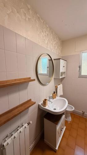 a white bathroom with a sink and a mirror at Gredos Tiétar in El Arenal