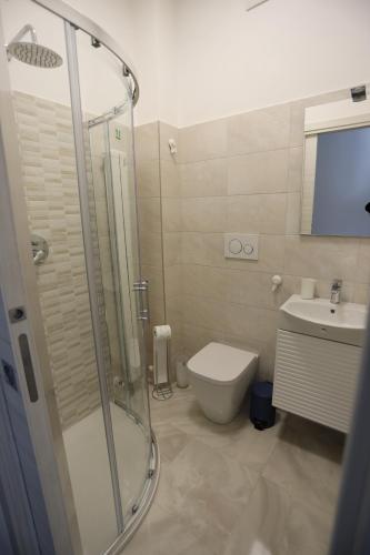 a bathroom with a shower and a toilet and a sink at La Genziana - villino con parcheggio privato in Popoli