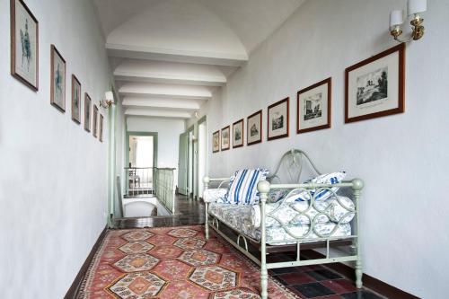 a hallway with a bed and pictures on the wall at Casa Giulia in Castagnole Lanze