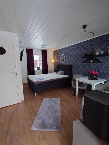 a bedroom with a bed and a living room at Jävregården in Jävre
