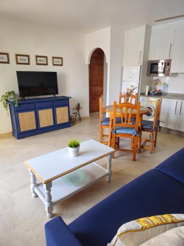 a living room with a table and a kitchen at Casa Indalo Vera Coast in Vera