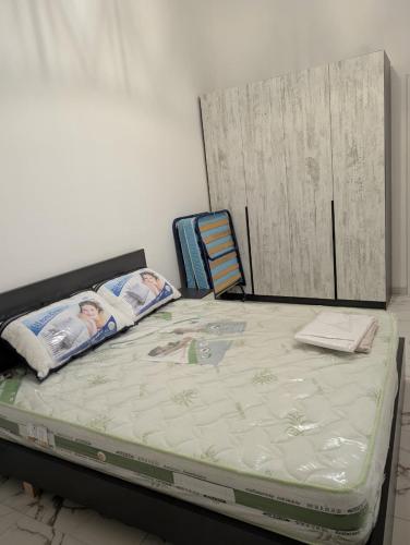 an empty bed with two children laying on it at Erna Apartment in Golem