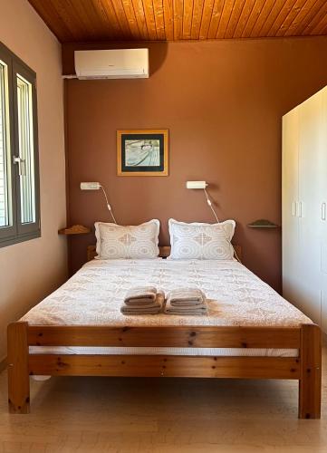 a bedroom with a large bed with two lamps at Mia's Atelier in Kamária
